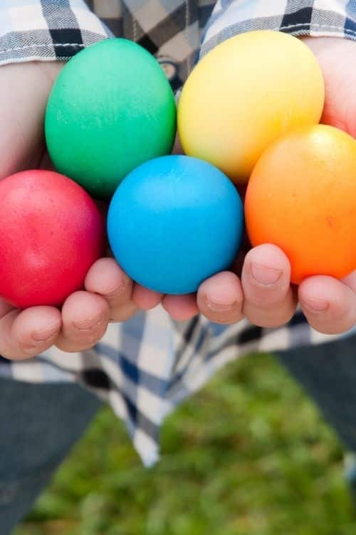 Finding eggs of all colors on an Easter Scavenger Hunt Game. This Easter challenge turns into a treasure hunt for adults.