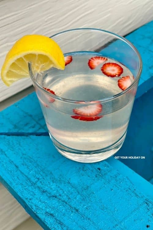 cut up strawberries added to lemonade to make strawberry lemonade.