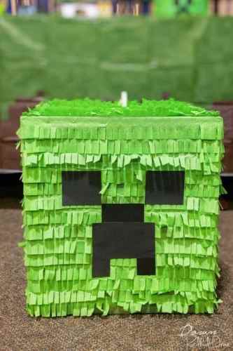 Homemade Minecraft pinata diy that is green with a black face.