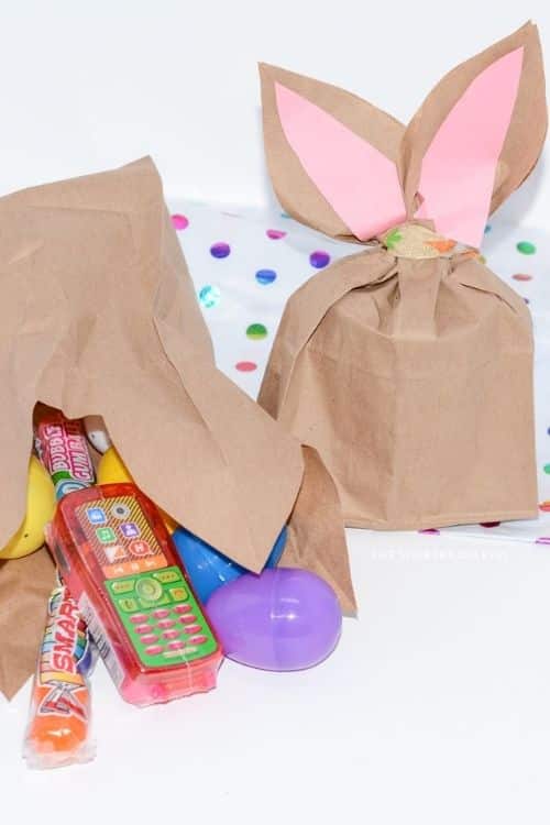 The paper Easter bunny bag filled with goodies and candy treats.