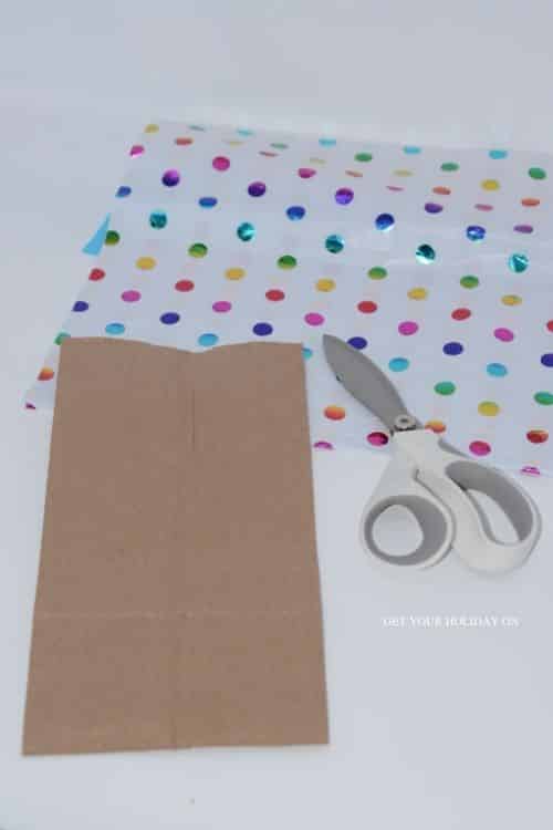 Start with a brown paper bag and scissors.