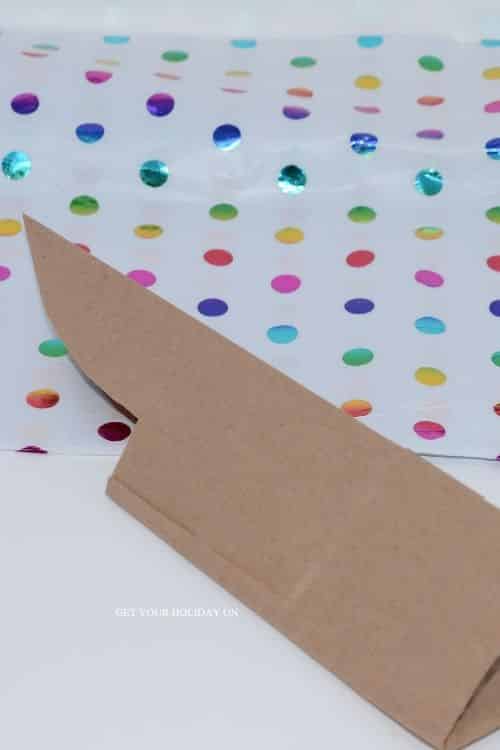 Cut two ears and across the middle of the paper bag for an easter bunny bag pattern.