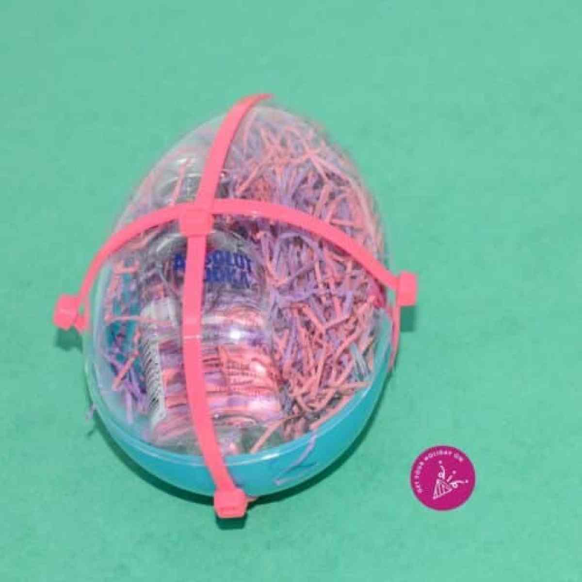 An Easter egg with bowties that is locked up booze for a fun twist to an adult Easter egg hunt with booze.