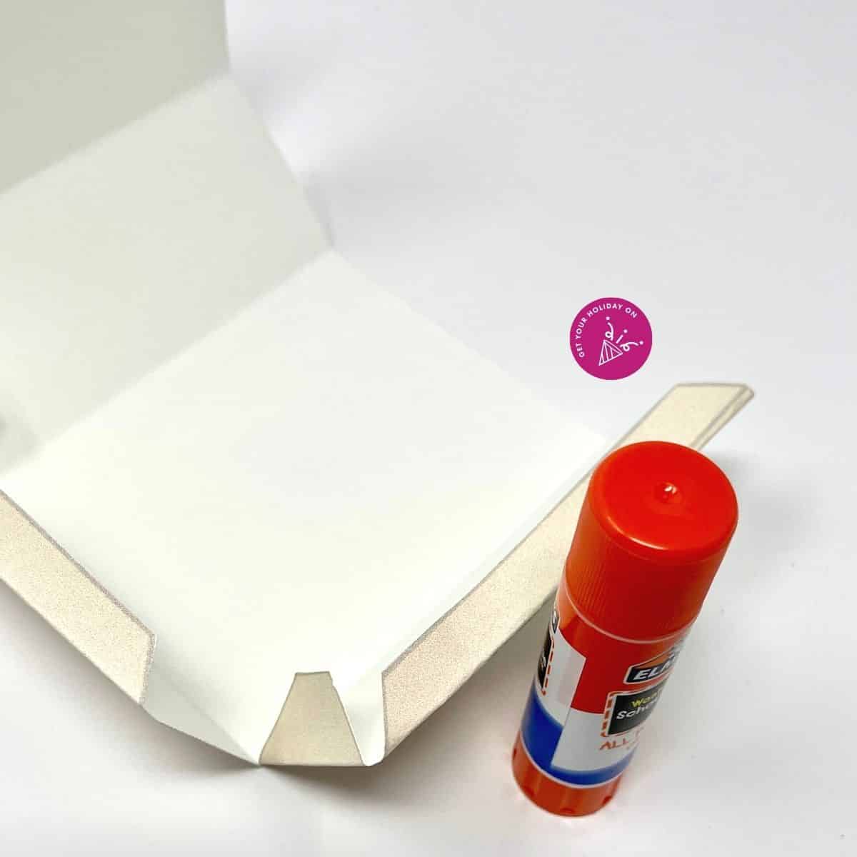 DIY adult party favor cardstock box that is printed and used for a dad bod belly and glued shut with a glue stick