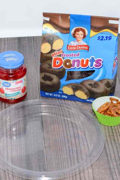 Merry Christmas donuts Merry Christmas donuts using mini frosted donuts, cherries, and pretzels.