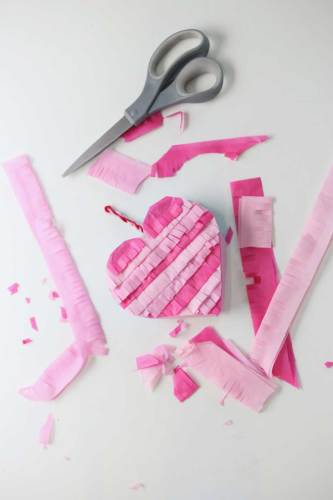 Easy to make mini heart pinata that are pink and made with Crete paper.