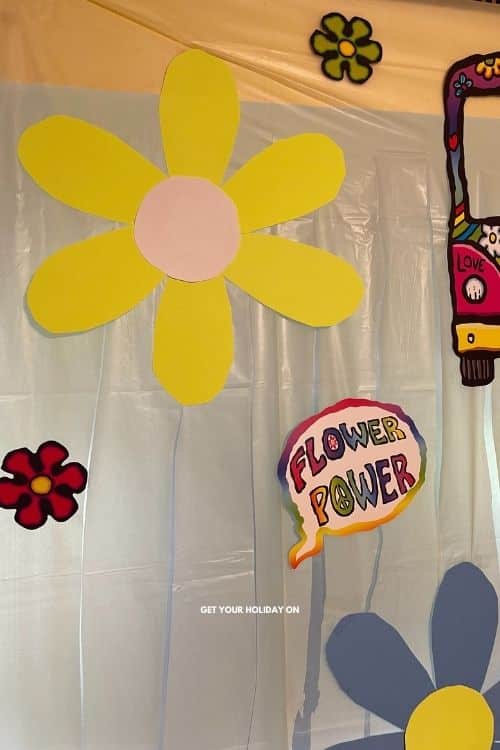 flowers made out of poster board and placed on the diy tablecloth for a tie dye feel.