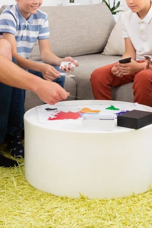 Two boys trying to play a game so they could win a small prize or a medium prize.