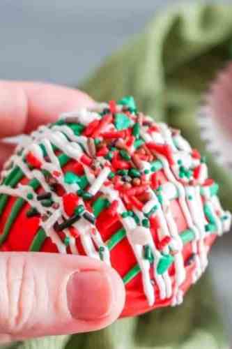 red and green sprinkled with different colored chocolate on a red ball.