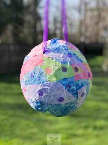 A balloon pinata with paper Mache and ribbon to hang.