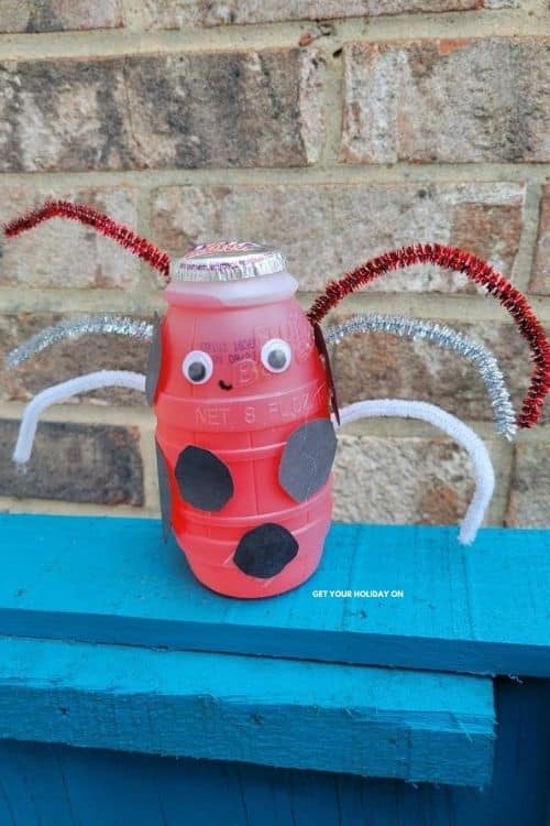 Ladybug craft with pipe cleaners, googly eyes, black construction paper and smile.