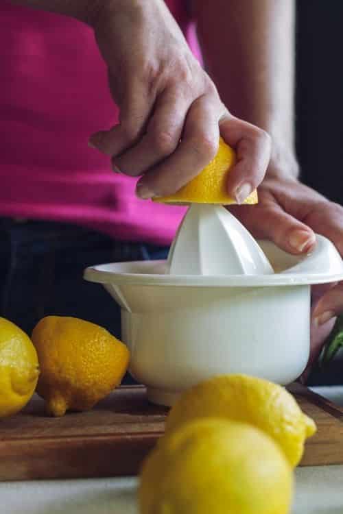 Mom preparing lemonade for her kids.