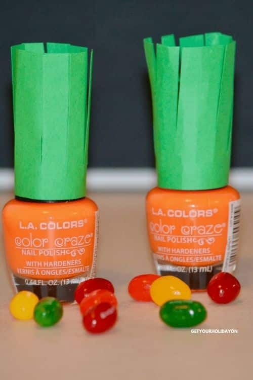 A fun way to dress up an Easter Basket is with this Easter Nail polish diy. In this photo is two orange nail polish bottles dressed up like carrots for the spring.
