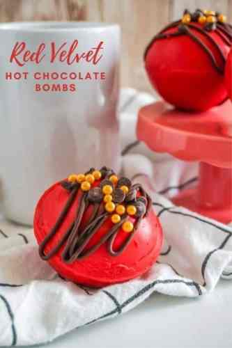 red velvet hot chocolate bombs with sprinkles and mini chocolate chips on top.