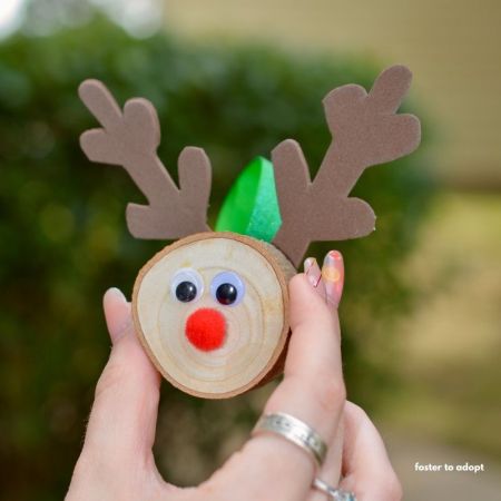 wood slice ornament decorated like a reindeer for the holidays.