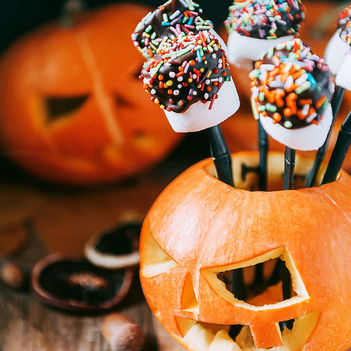 Sprinkle dipped Halloween Marshmallow Pops Sprinkle-dipped Halloween Marshmallow Pops with chocolate and sprinkles.
