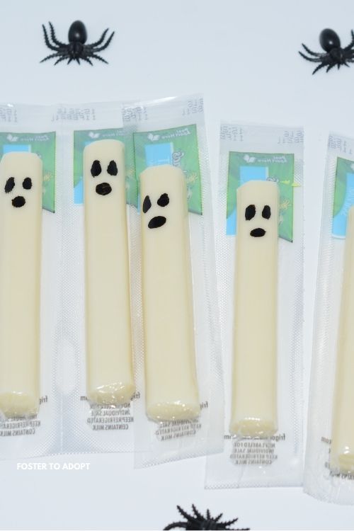String Cheese Ghosts String cheese with ghosts drawn on them.